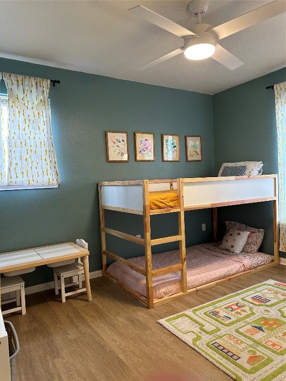 1301 NE 2nd St, Smithville, TX 78957 - bedroom with baseboards and wood finished floors