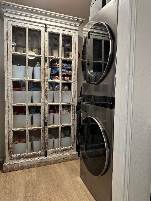 1301 NE 2nd St, Smithville, TX 78957 - washroom featuring stacked washer / dryer, laundry area, and wood finished floors