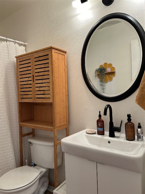 bathroom with vanity and toilet