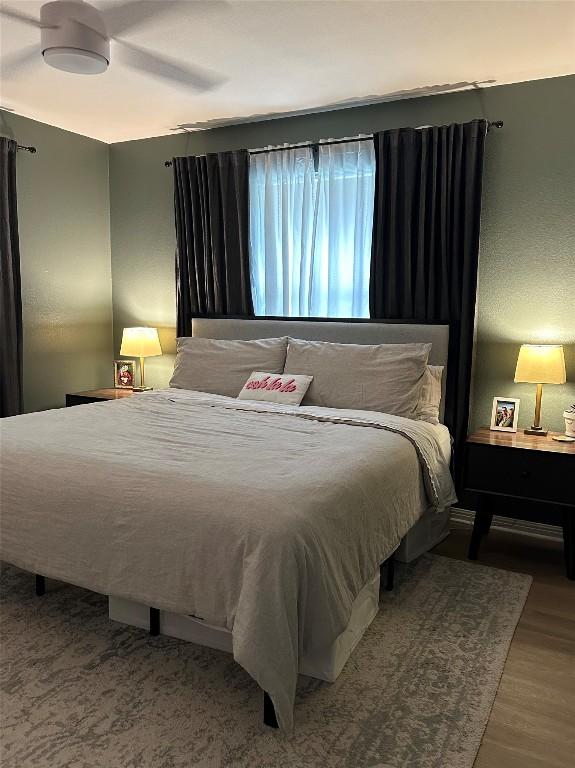 bedroom featuring ceiling fan and hardwood / wood-style floors