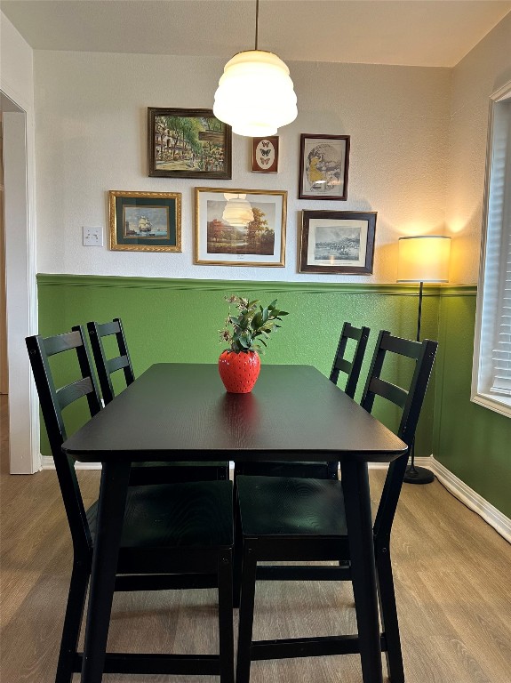 dining space featuring wood-type flooring