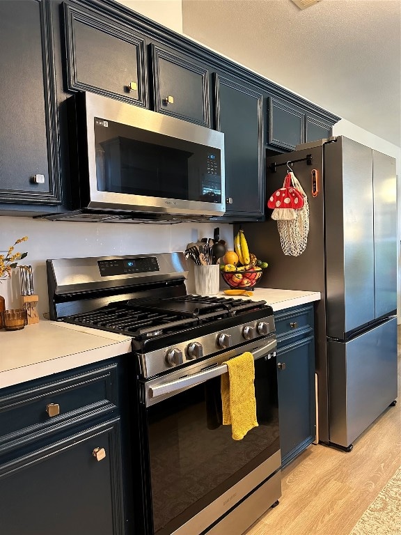 kitchen featuring light hardwood / wood-style floors and appliances with stainless steel finishes