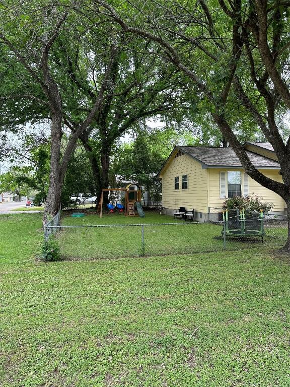 1301 NE 2nd St, Smithville, TX 78957 - view of yard with fence and a playground
