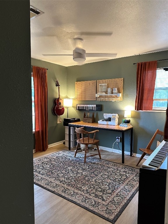 office with ceiling fan, a textured ceiling, and wood-type flooring