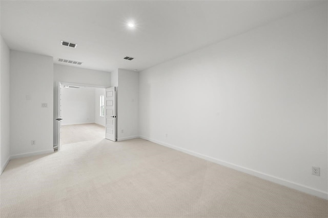 empty room with light colored carpet