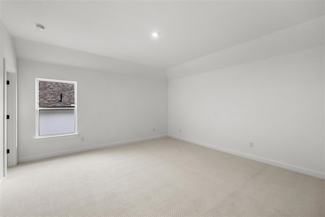 unfurnished room with light carpet