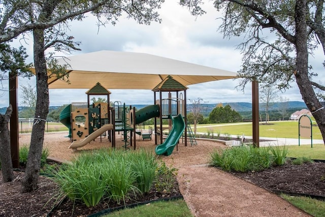 view of play area featuring a mountain view and a yard