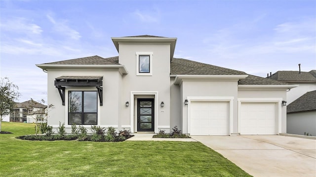 view of front of property featuring a garage and a front lawn