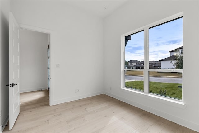 unfurnished room featuring plenty of natural light and light wood-type flooring