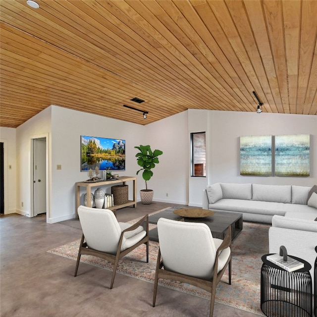 living room featuring track lighting, wooden ceiling, concrete floors, and baseboards