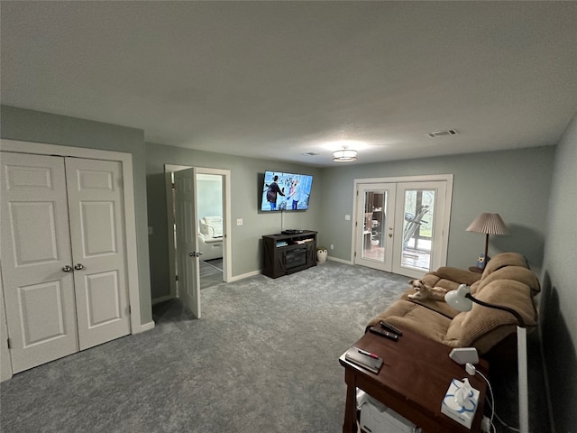 living room with dark colored carpet and french doors