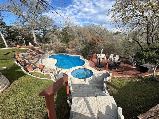 view of pool with a lawn and a wooden deck