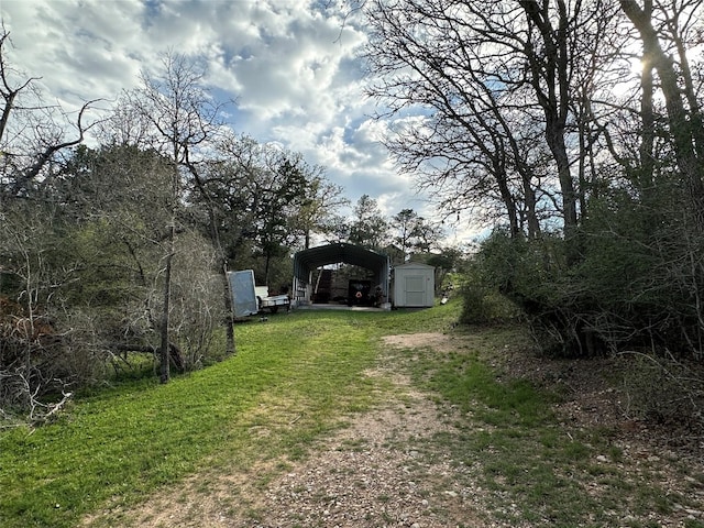 view of yard featuring a storage shed and a carport