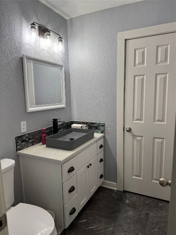 bathroom featuring toilet, large vanity, and tile flooring