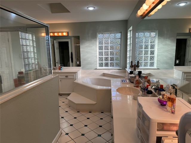 bathroom featuring vanity, a washtub, and tile floors