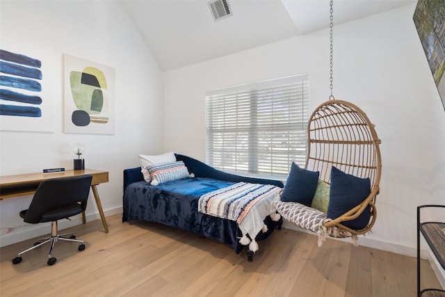 bedroom featuring light hardwood / wood-style flooring and lofted ceiling