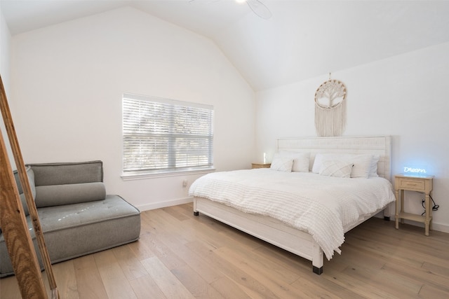 bedroom with light wood-type flooring and vaulted ceiling