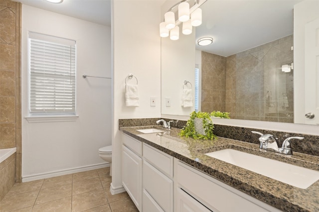 bathroom with tile patterned floors, vanity, toilet, and tiled shower