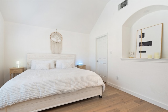 bedroom with wood-type flooring and lofted ceiling