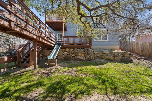 rear view of property with a yard and a deck