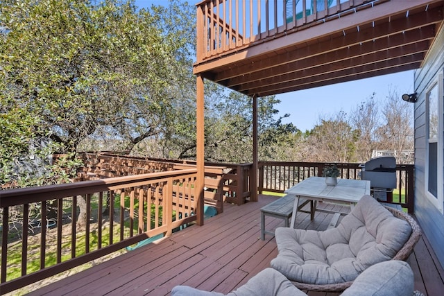 wooden deck with a grill