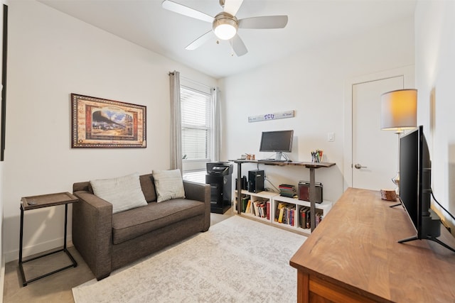 carpeted home office with ceiling fan