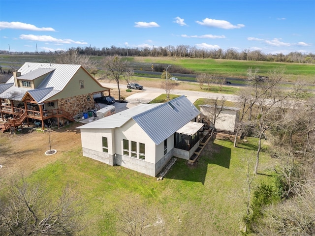 birds eye view of property with a rural view