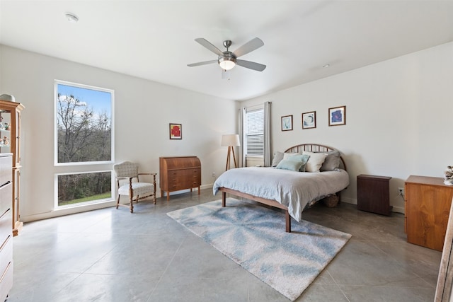 tiled bedroom featuring ceiling fan