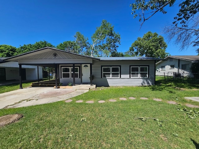 ranch-style home featuring a carport and a front yard