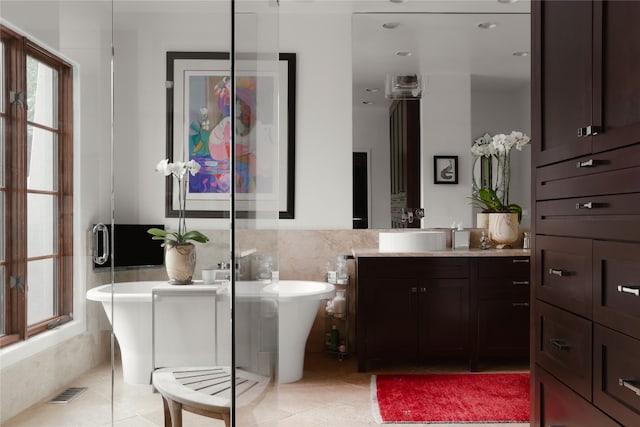 bathroom with tile walls, tile floors, a bathtub, and oversized vanity