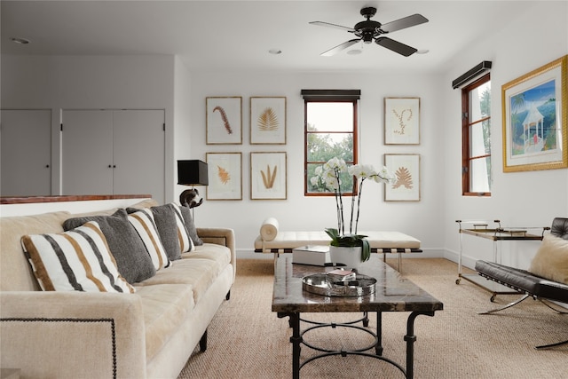 carpeted living room featuring ceiling fan