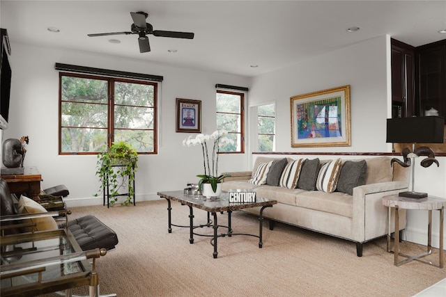 carpeted living room with ceiling fan