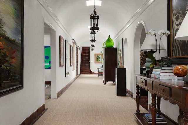 429 Sunfish St, Lakeway, TX 78734 - corridor featuring baseboards, light carpet, arched walkways, ornamental molding, and lofted ceiling