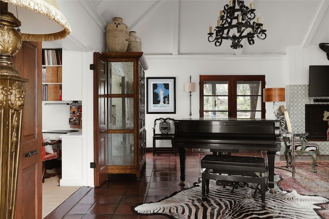 misc room featuring crown molding, a notable chandelier, and dark tile floors