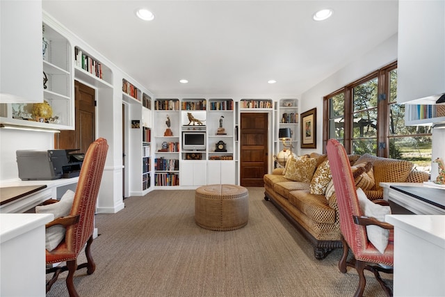 carpeted home office featuring built in shelves