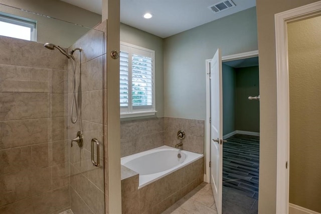 bathroom featuring independent shower and bath and tile flooring