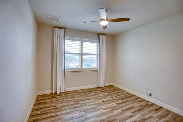 empty room featuring ceiling fan and light wood-type flooring