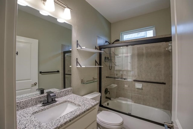 full bathroom featuring shower / bath combination with glass door, toilet, and vanity