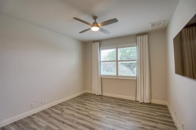 unfurnished room featuring ceiling fan and light wood-type flooring