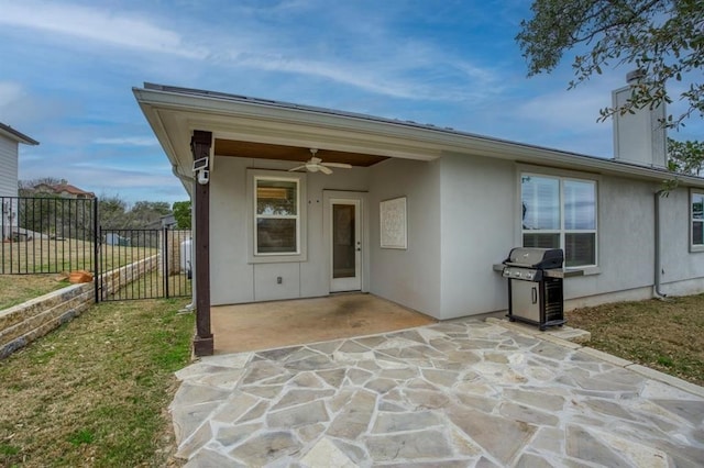 rear view of property featuring a patio and ceiling fan