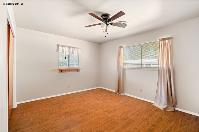 spare room with hardwood / wood-style floors and ceiling fan