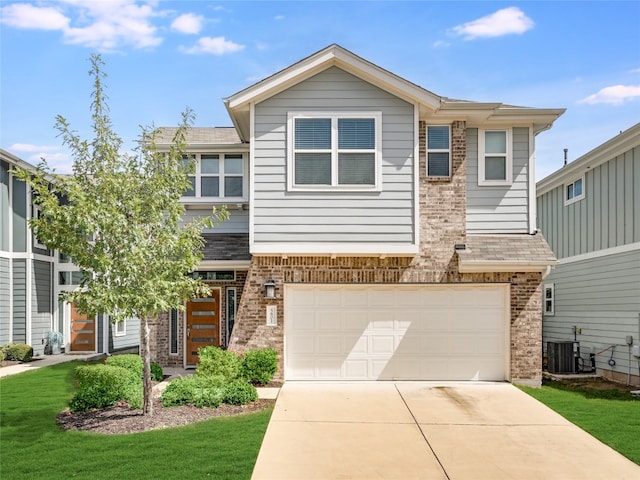 view of front of property featuring central air condition unit, a front lawn, and a garage