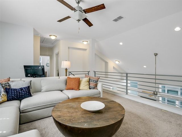 carpeted living room with ceiling fan