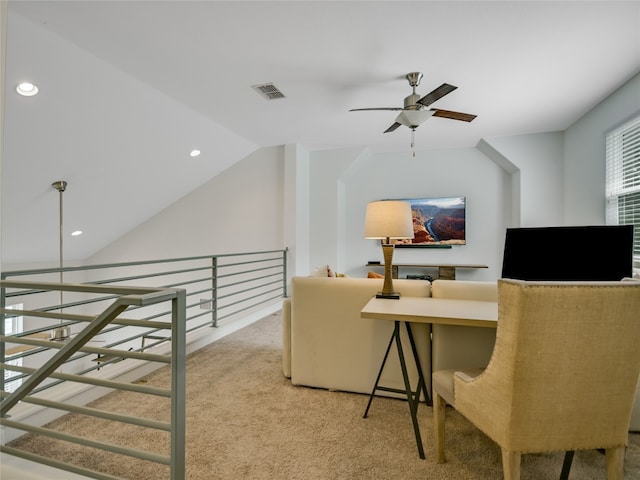 carpeted living room with ceiling fan and lofted ceiling