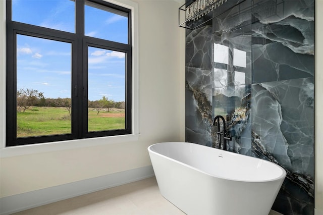 bathroom with tile walls, tile floors, and a bathtub