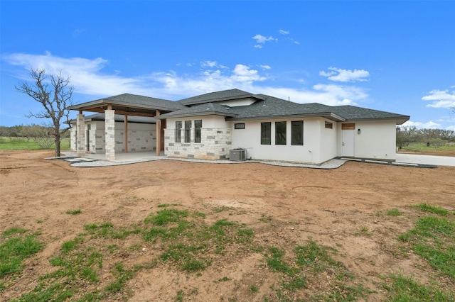 back of property featuring central AC unit