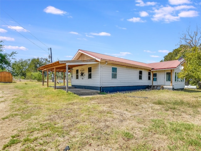 back of property featuring a yard