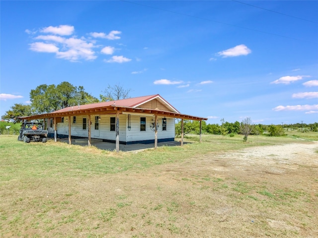 rear view of property with a yard