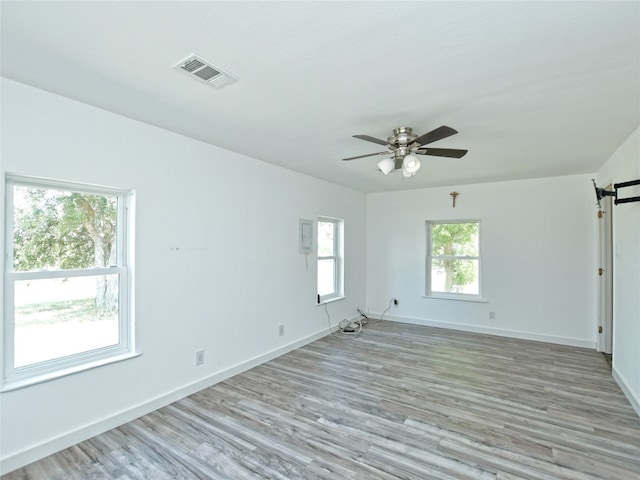 spare room with ceiling fan and light hardwood / wood-style flooring