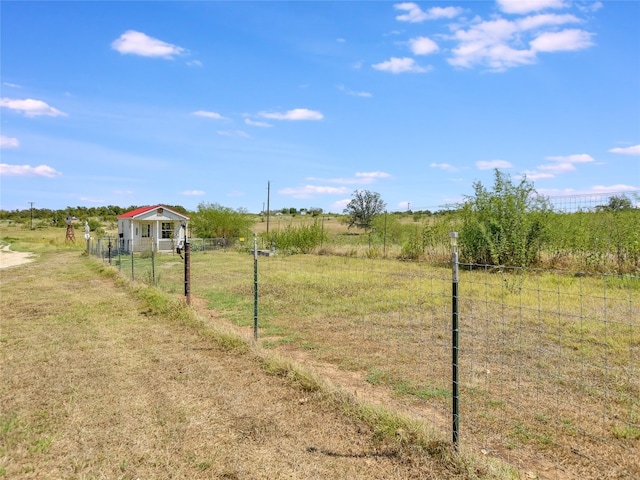 view of yard with a rural view